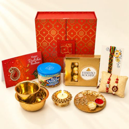 LOVENSPIRE Brocade Gift Box Raksha Bandhan Hamper for Brother and Bhabhi - Includes 2 Traditional Handmade Rakhi, Chocolates Pack, Candle & Haldi Kumkum Holder, Greeting Card with Roli Chawal - color: Premium Hamper
